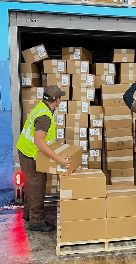 Honeybee team loading boxes onto a UPS truck